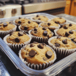 Banana chocolate chip muffins on rustic wooden table